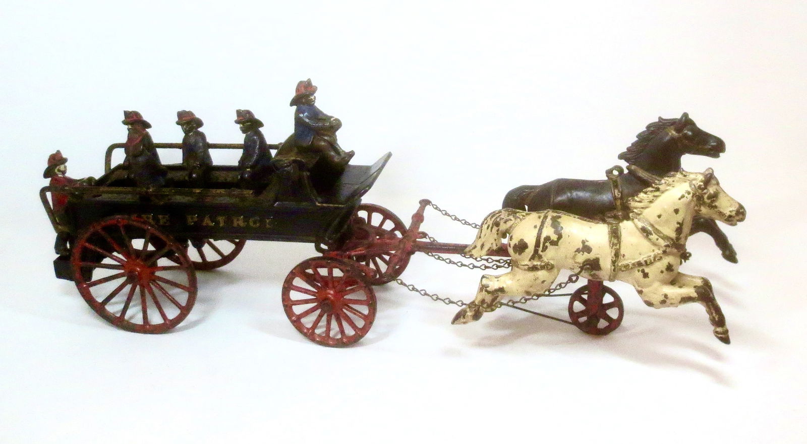 Dent Hardware Cast Iron Fire Patrol Toy: Circa 1905. 21" Long. 8 pieces. Fair condition (missing two firemen and bell mechanism). Unboxed.