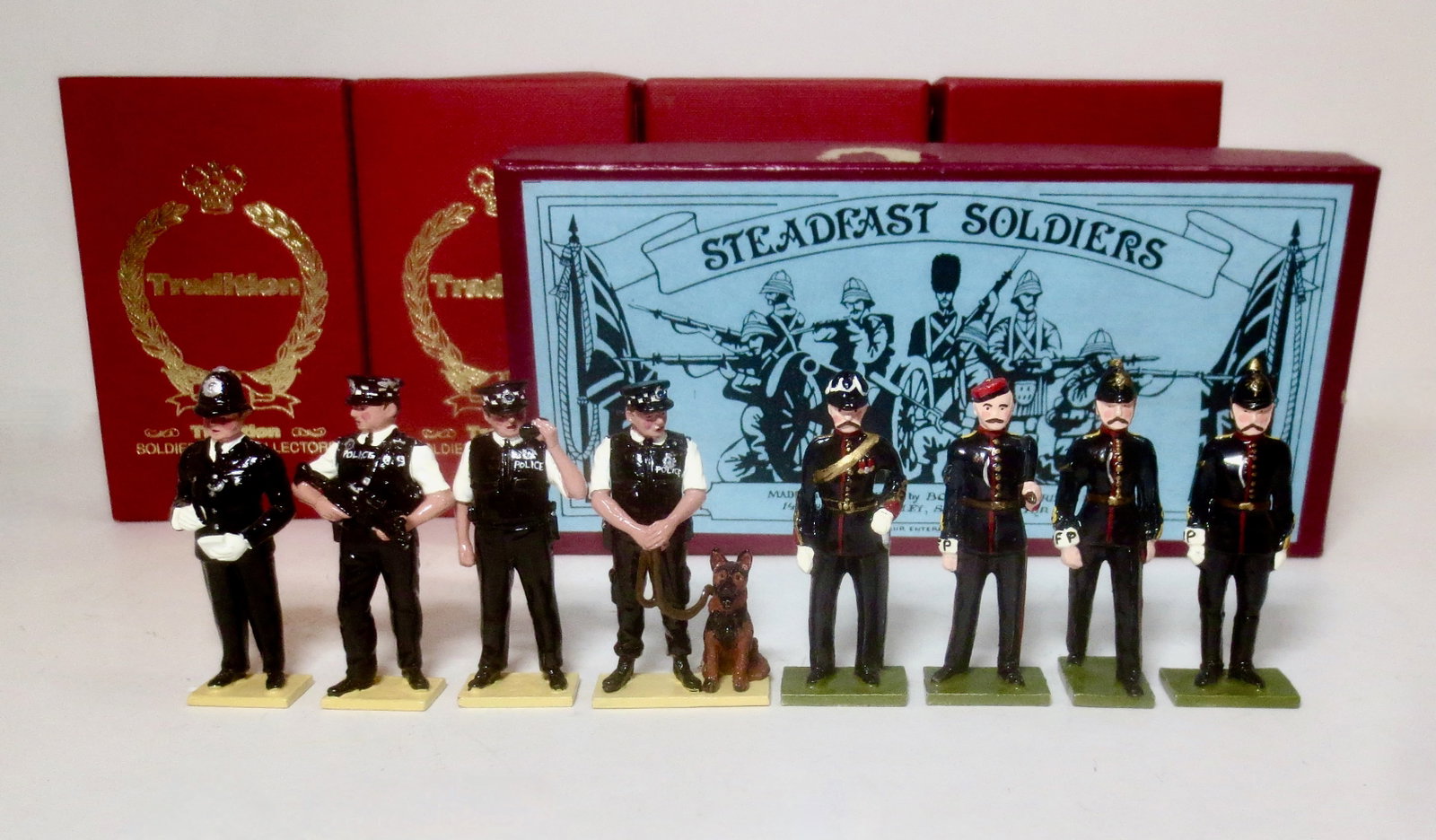 Tradition & Steadfast Police Figures: Steadfast #22 Military Police, and Tradition #565, 566, 568 & 569 British Police Figures. 8 pieces. Mint condition. Boxes excellent.