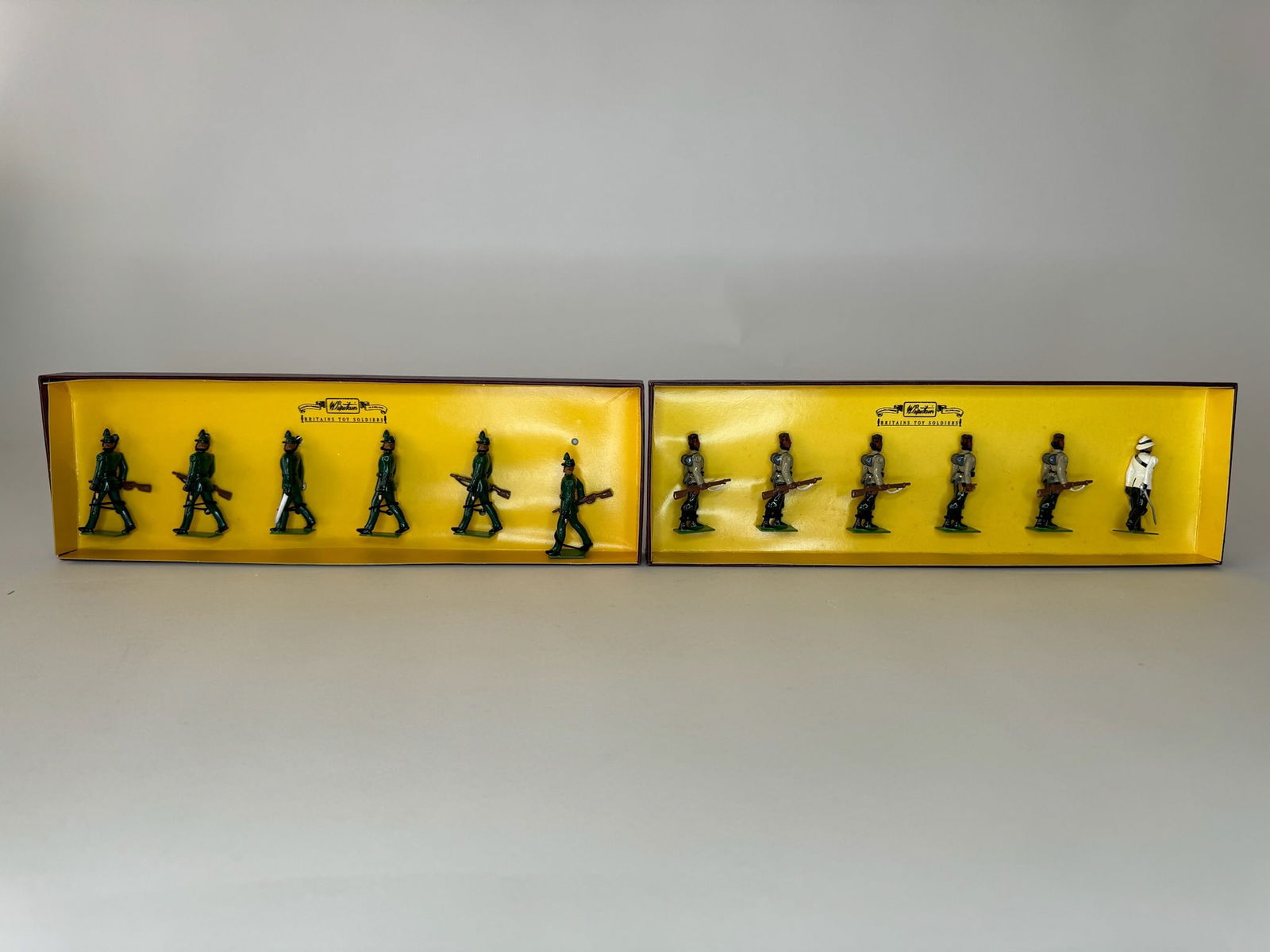 Britains No 8841 & 8891 Gurkha Rifles and London: Rifle Regiment. 2 sets. Tied in original boxes. 12 pieces total. Excellent condition. Boxes excellent.