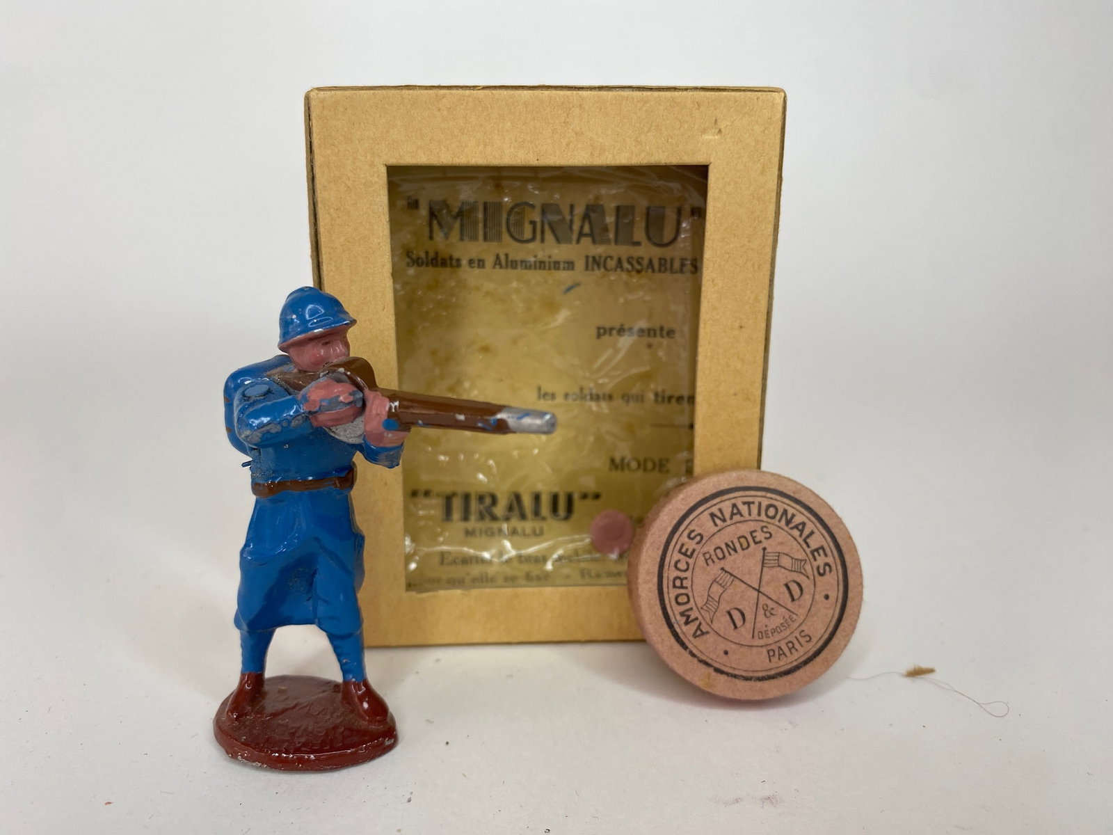 Mignalu French Line Infantry in Horizon Blue: Very rare aluminium figure made in France. This standing figure fires live caps. His right hand is spring loaded and when a cap is placed against the rifle and his hand is released, he fires in a real