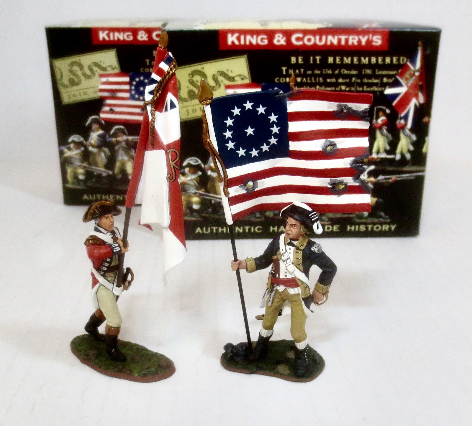 King & Country American Revolution Figures: #BR036 British Officer with Regimental Flag, and #AR035 American Standing Flagbearer. 2 pieces. Mint condition. Box excellent.