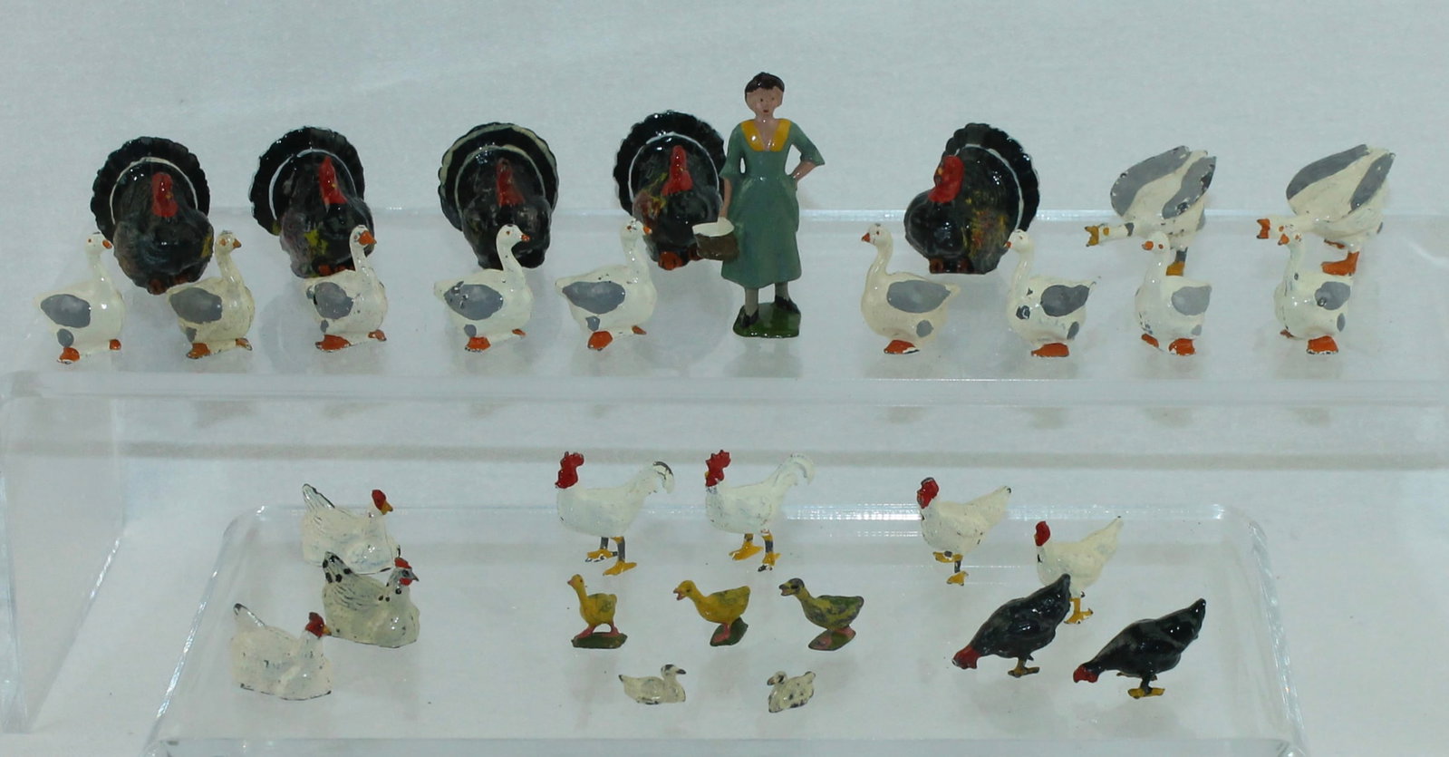 Britains Farm Fowl Lot: Farm Series. Lot includes 532 Milkmaid Carrying Pail, 5 of 515 Turkey, 3 of 545 Sitting Hens, 2 of 519 Angry Gander, 4 of 570 Geese and Others. 31 Pieces. Condition Very Good to Excellent. No Box.
