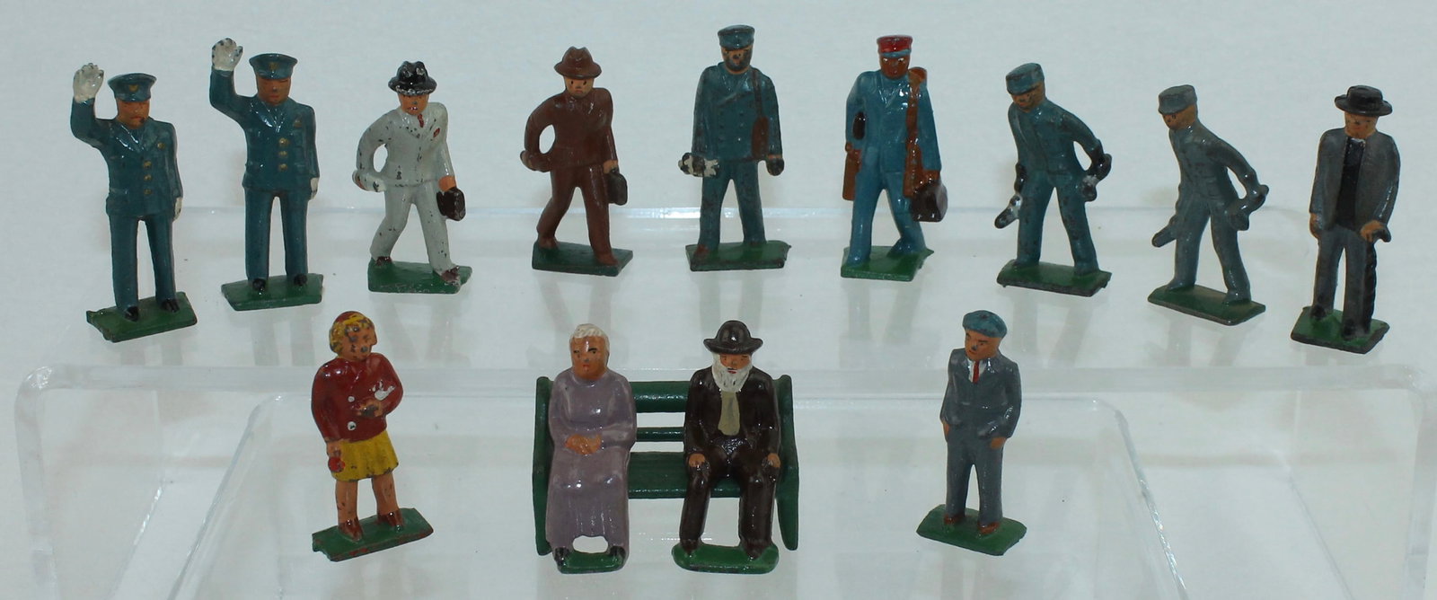 Grey Iron Lot American Family Travels: American Family Travels Series. Lot Includes T 3 Boy, T 4 Girl in Dress, T 11 Porter, T 8 Policeman and Others. 14 Pieces. Condition Good to Very Good. No Box.