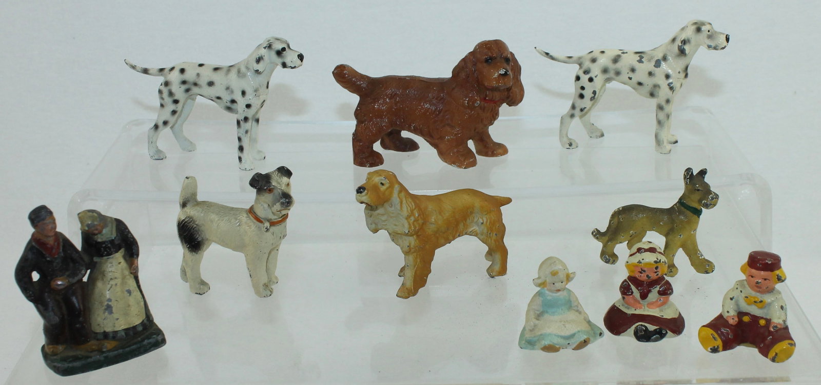 Hubley Lot of Dogs: Lot includes Dalmation, Springer Spaniel, Fox Terrier, Seated Children Possibly by Hubley and Cast Iron Couple by Unknown Maker. 10 Pieces. Condition Good to Very Good. No Box.