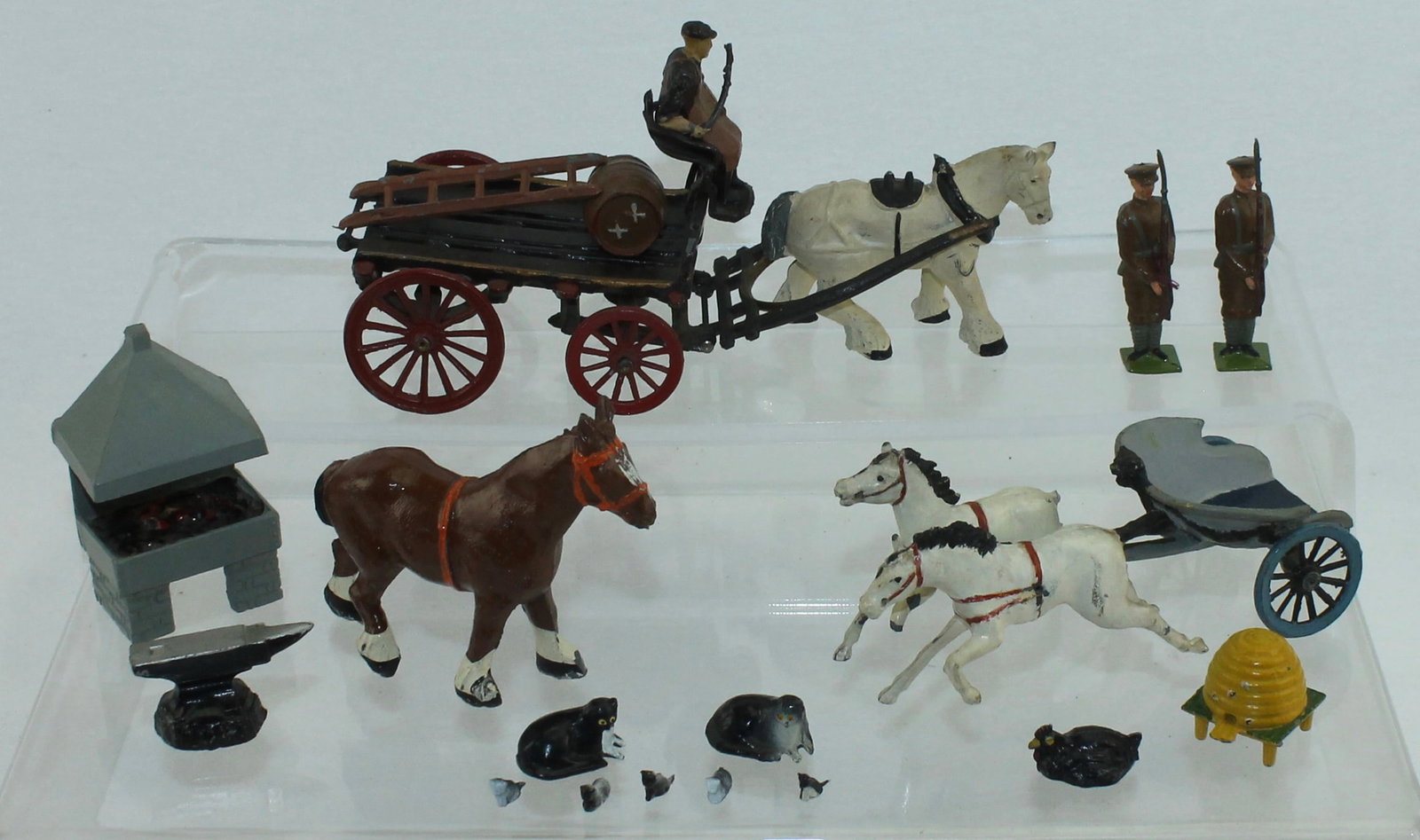 Taylor & Barrett Lot Brewer's Dray: Lot includes Brewer's Dray with One Barrel, Blacksmith with Forge and Horse, Bee Hive and Others. Brewer's Dray Incomplete - lacking Watneys Beer Advertizing Sign. 22 Pieces. Condition Very Good. No B