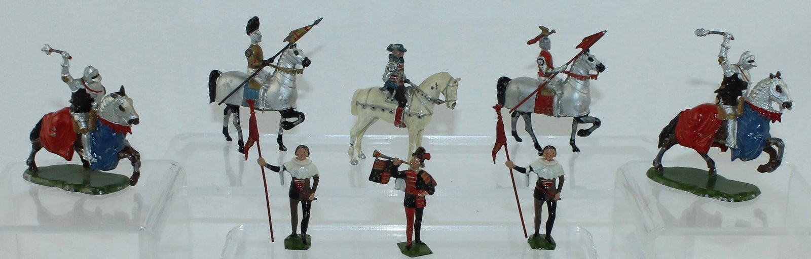 Britains Agincourt Knights and Set 1258 Knights: Lot includes Set 1258 Knights with Squires, Herald and Marshal along with 2 from Set 1659 Agincourt Knights. 8 Pieces. Condition Fair to Very Good. Shield Loose on Agincourt Knights. No box.