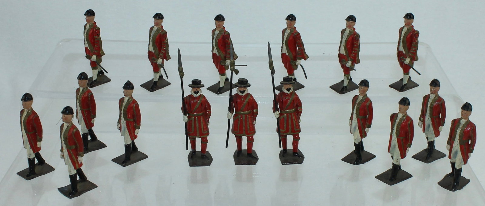 Britains From Set 1475 State Coach Attendants: Attendants to the State Coach. Lot includes 3 Yeomen, 8 Walking Outriders and 6 Footmen with Swords. 17 Pieces. Condition Very Good. One Sword Missing. No Box.