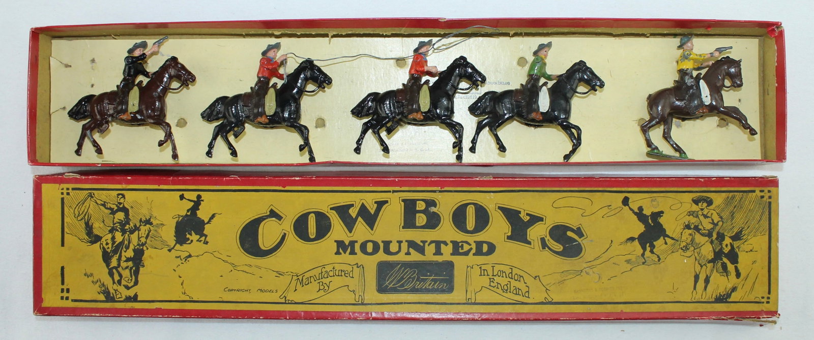 Britains Lot From Set 179 Mounted Cowboys: 5 Pieces. Condition Good. One Lasso Missing. One Horse Tail Broken. One Arm Missing. One Pistol Broken. Box Good.