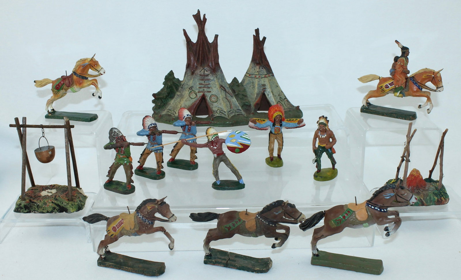 Elastolin Lot North American Indian Encampment: Composition. 7cm. Includes Charging Horse with Squaw and Child, 4 Riderless Horses, Teepee Duplex, Assortment of Indians in Battle Poses and 2 Cooking Fires. 15 Pieces. Condition Fair to Very Good. St
