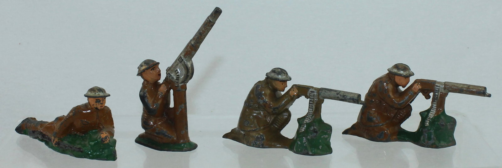 American Metal Toys Lot Machine Gunners: Lot includes AM8 Anti Aircraft Gun, 2 of AM10 Seated Machine Gunner and AM14 Lying with Rifle on Side. 4 Pieces. Condition Fair to Good. No Box.