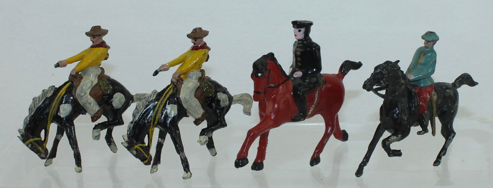 Metal Cast Lot American Cavalry, Cowboys: Lot includes #21 American Cavalry with Paint Variation of Blue over Red, #31A Calvary Officer in Cap and 2 of #31 Cowboy on Bucking Bronco. 4 Pieces. Condition Good to Excellent. No Box.