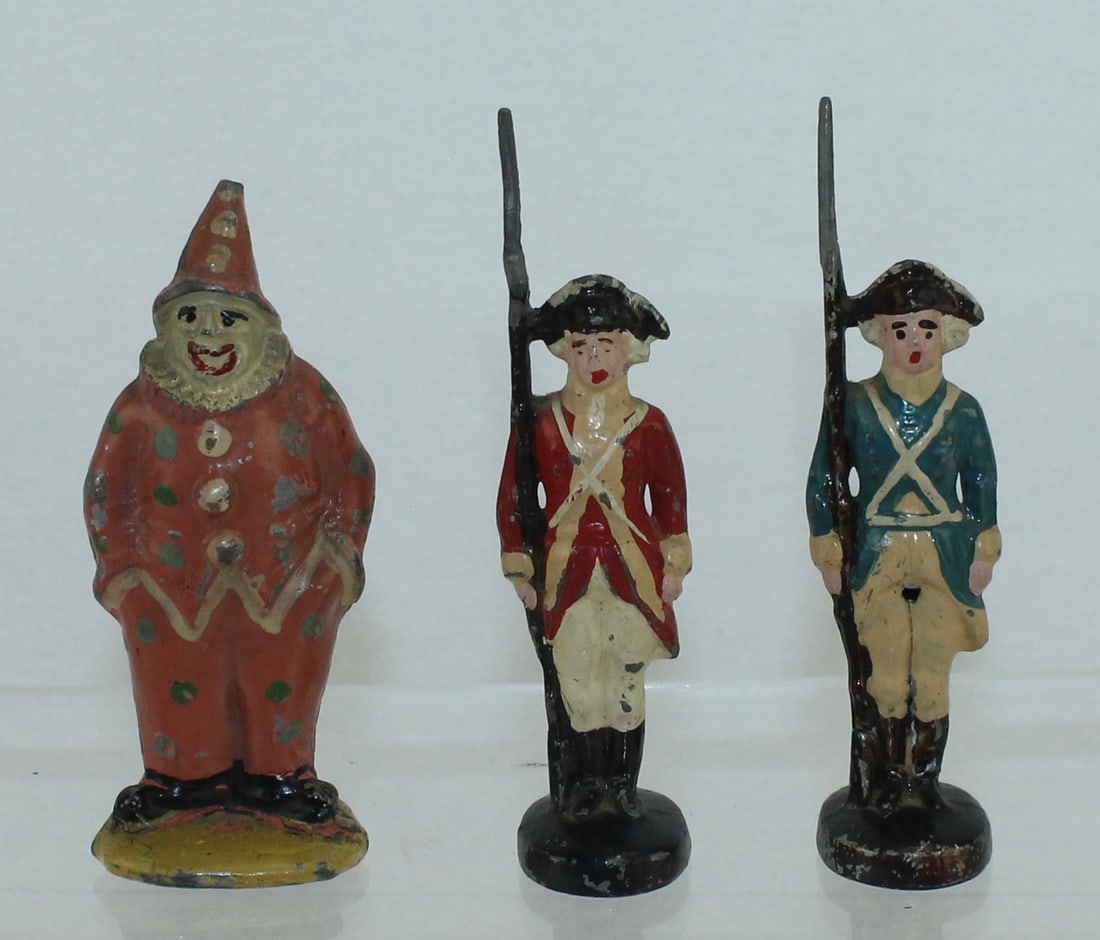 Metal Cast Lot of Souvenirs: Lot includes British and American Infantry from the American Revolution and a Circus Clown. 3 Pieces. Condition Good. No Box.