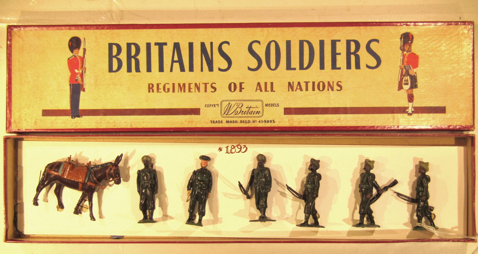 Britains No 1893 Indian Army Service Corps: Britains Ltd # 1893. Indian Army Service Corps with mule and handler. 7 pieces in original ROAN box. With new tie-card. Condition Excellent. Box Excellent.