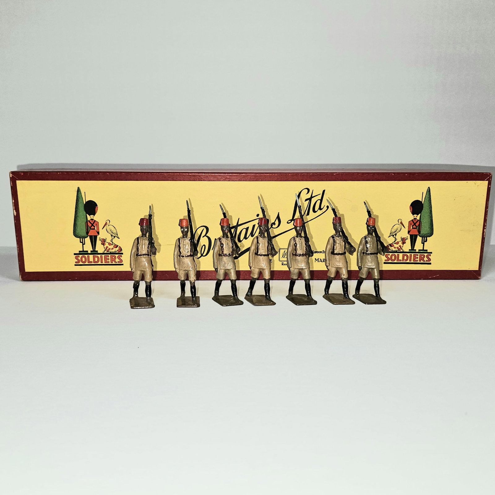 Britains No 225 Kings African Rifles: Britains Ltd. #225. Kings African Rifles 7 men marching in Britains "Soldiers" box with 7-hole tie card. Slight mismatch in color. 1966 only. Condition Very Good. Box Very Good.