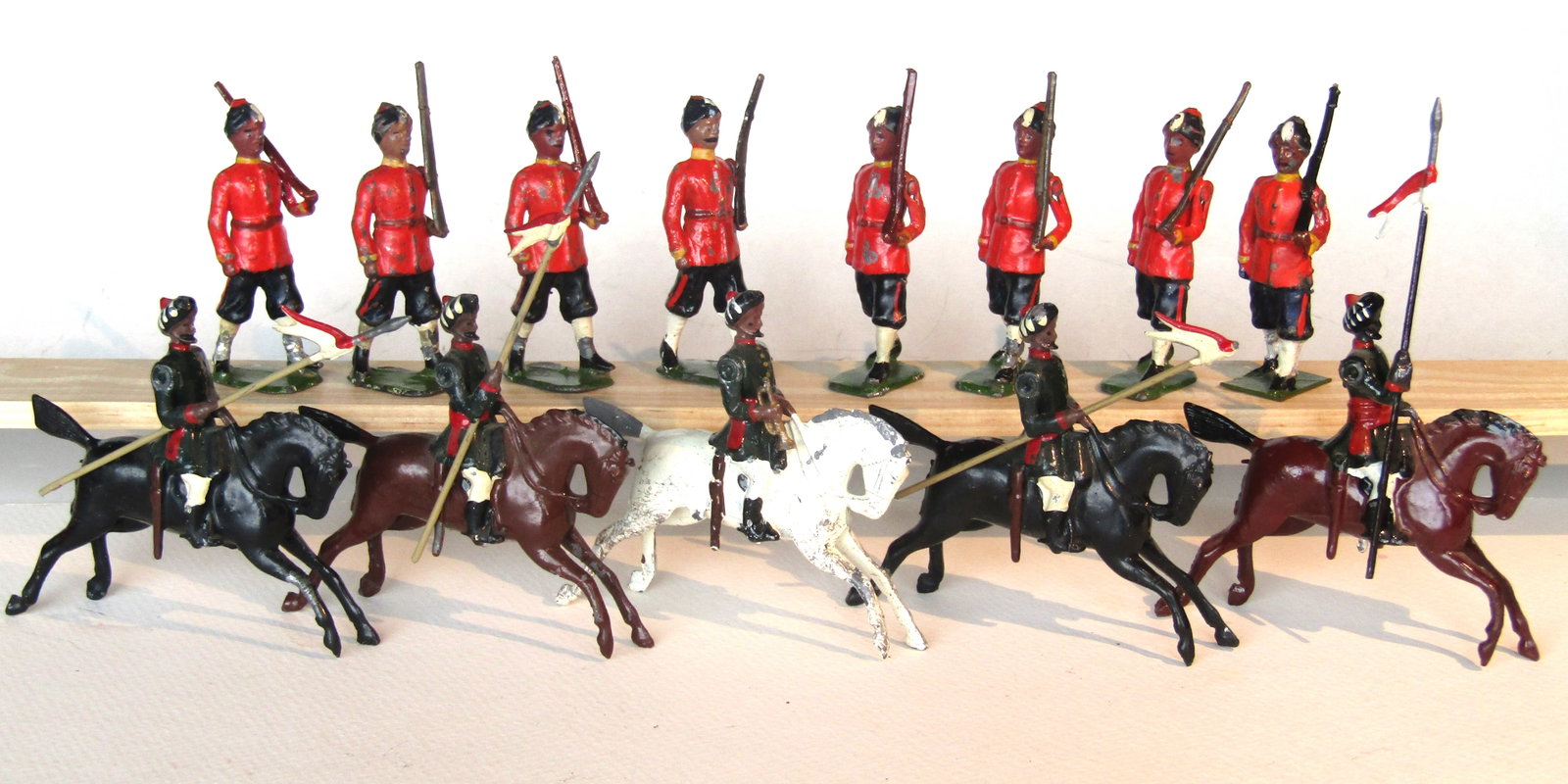 Britains No 66 13th Duke of Connaught's Own: Lancers. Britains Ltd. # 66. 13th Duke of Connaught's Own Lancers. 3rd Version (1950-1960) in dark blue kurtas w/trumpeter, and from #64, 7th Bengal Infantry, 2nd version (1916-41) with improved sepoy