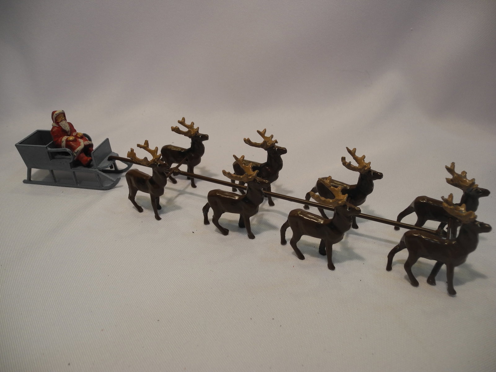 Santa in his Sled with 8 Reindeer: Santa in his Sled pulled by 8 reindeer. 11 pieces. Condition Very Good. Unboxed.