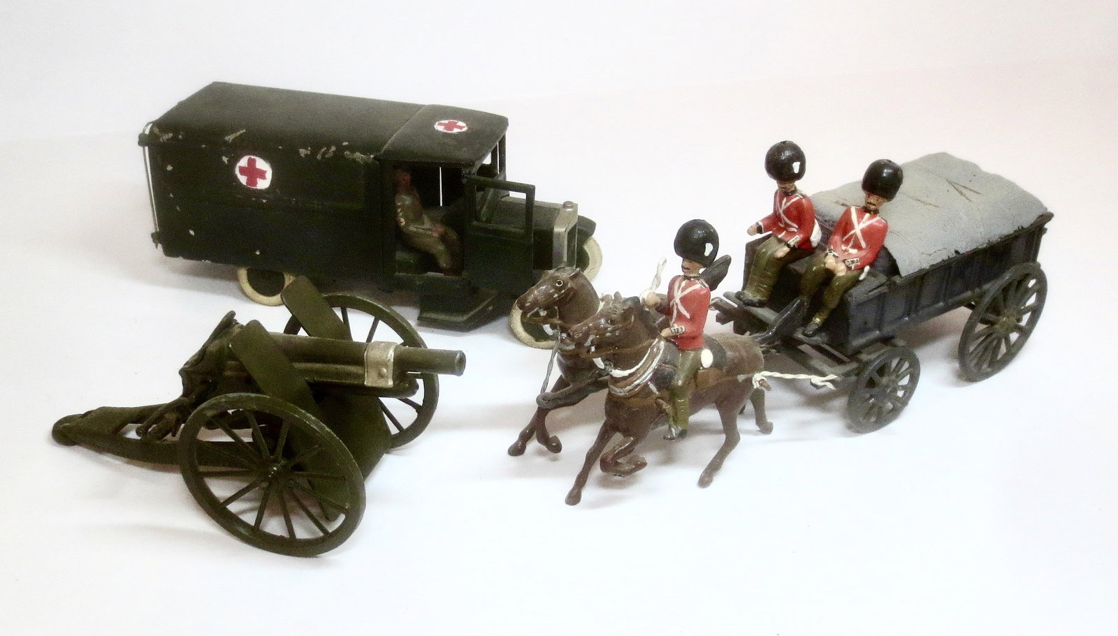 Britains Assortment: Field Artillery Gun in Near mint condition, Pre war Ambulance in poor condition, and Conversion Supply Cart in good condition. Unboxed.