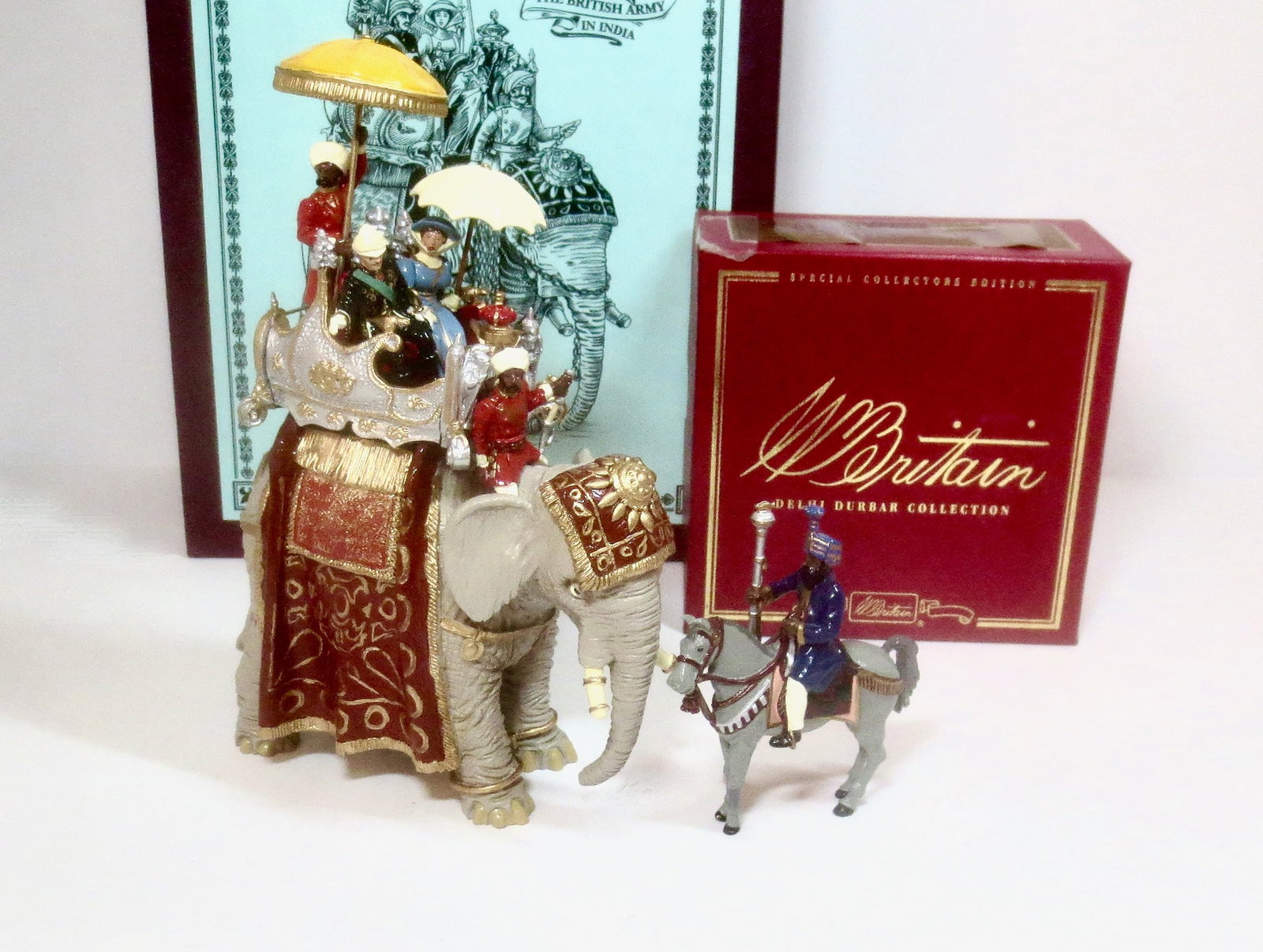 Britains #8848 Delhi Durbar Ceremonial Elephant: The Duke And Duchess of Connaught in Howdah. Plus, #40399 The Maharaj of Cutch's State Mace Bearer. 7 pieces. Mint condition. Boxes excellent to good (side label coming off Mace Bearer's box).