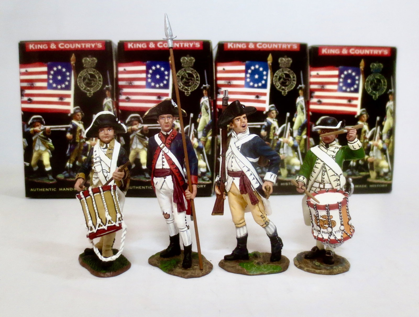 King & Country American Revolution Series: #AR037 American Drummer Boy, #069 Artillery Officer, #AR066 Sergeant with Rifle, and #AR050 Marine Drummer. 4 pieces. Mint condition. Boxes excellent.