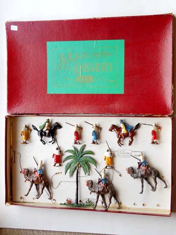 Britains From Set # 224 Arab Display: With Original Pre War Box and a mixture of Pre and Post War figures, 3 Arabs on Camels, 1 Palm Tree, 2 Arabs on horses, 6 Arabs Marching, partially tied in. 10 Pieces.