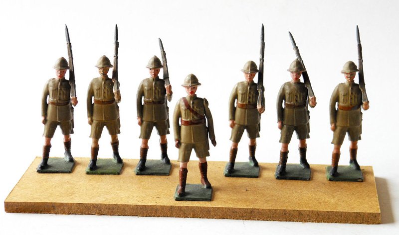 Britains from Set # 1294: Rare British Infantry in Tropical Dress /Men in shorts. Pre War 7 Pieces including Officer. Unboxed. These items have been glued to a wooden board for display purposes.