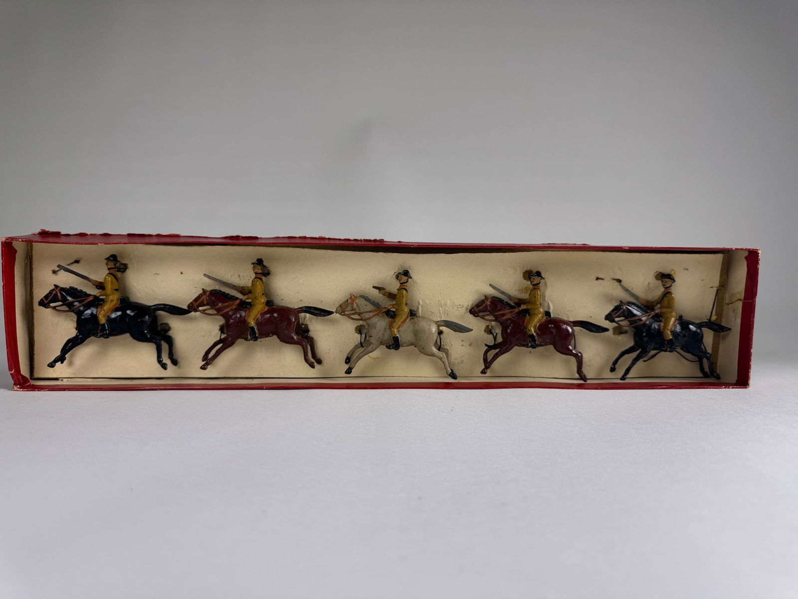 Britains No 6 Boer Cavalry: Circa 1899. Mounted fixed armed officer with pistol and 4 mounted field arm troopers with rifles. 5 pieces. Condition excellent with minor age wear. Box excellent with original tie card.