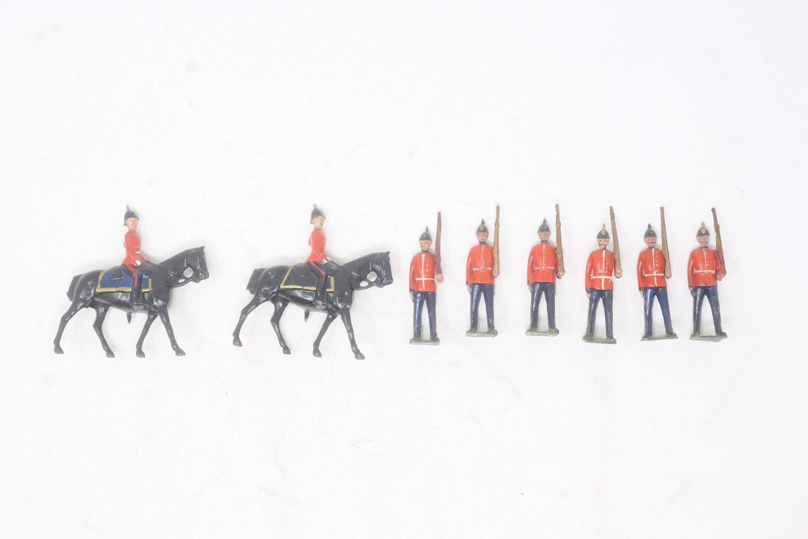 Britains from set #36 Royal Sussex Reg't: at slope, 7 pieces, including mounted officer; blue helmets plus one extra mounted officer (walking horse); Excellent