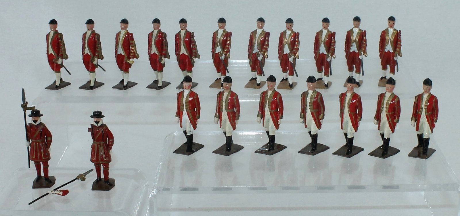 Britains From 1475 Attendants to the State Coach: Lot includes 11 Footmen with Sheathed Swords, 7 Outriders on Foot and 2 Yeomen with Pikes. 20 Pieces. Condition Very Good to Excellent. Three Damaged Swords. One Yeoman Arm Damaged. No Box.