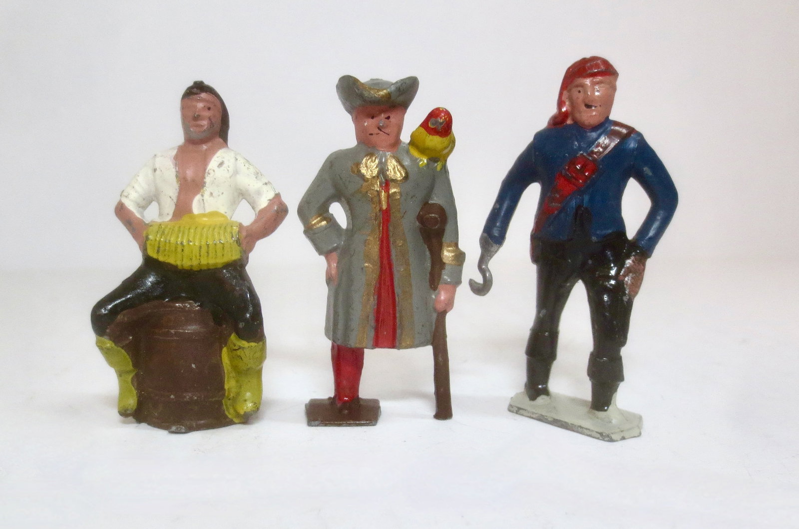 Johillco Pirate Trio: Long John Silver with crutch and parrot, pirate playing accordion on barrel, and pirate with hooked arm. 3 pieces. Excellent condition.