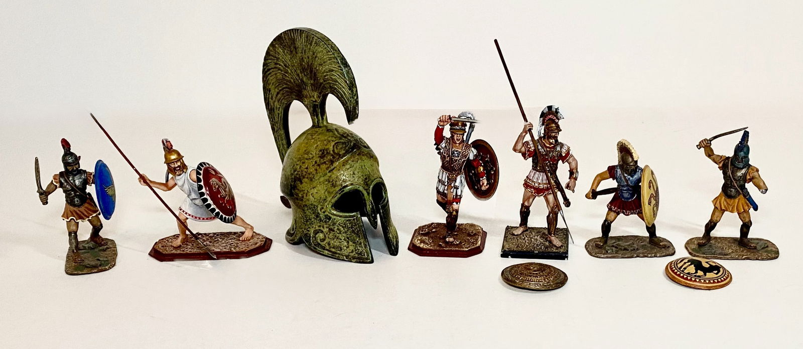 Assorted Greek Warriors: Plus a Bronze Helmet. Two Russian Studio figures, one East of India, and one St. Georges. Two with loose shields, the rest in excellent condition. Unboxed.