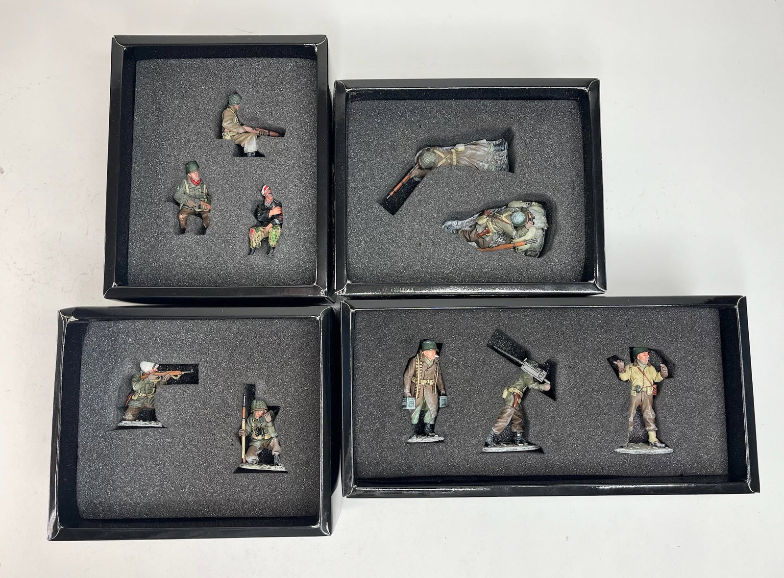 King & Country Battle of The Bulge Set Assortment: BBA020 Winter Command Group, BBA023 Winter Sniper Team, BBA025 Moving Up the Line, BBA036 Half-Track Passenger. 10 Pieces. Condition Excellent. Boxes Excellent.