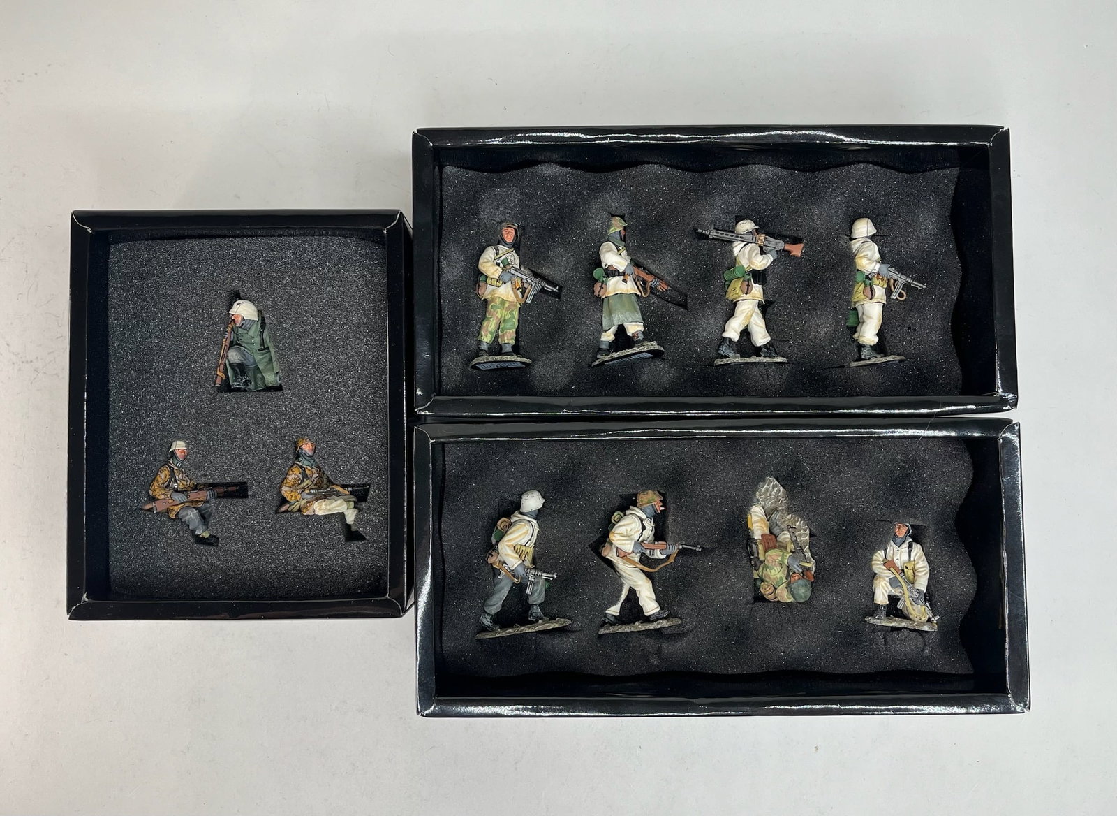 King & Country Battle of Bulge German Assortment: BBG002 Winter Patrol, BBG006 Crossing the Road, BBG017 King Tiger Tank Riders. 11 Pieces. Condition Excellent. Boxes Excellent.