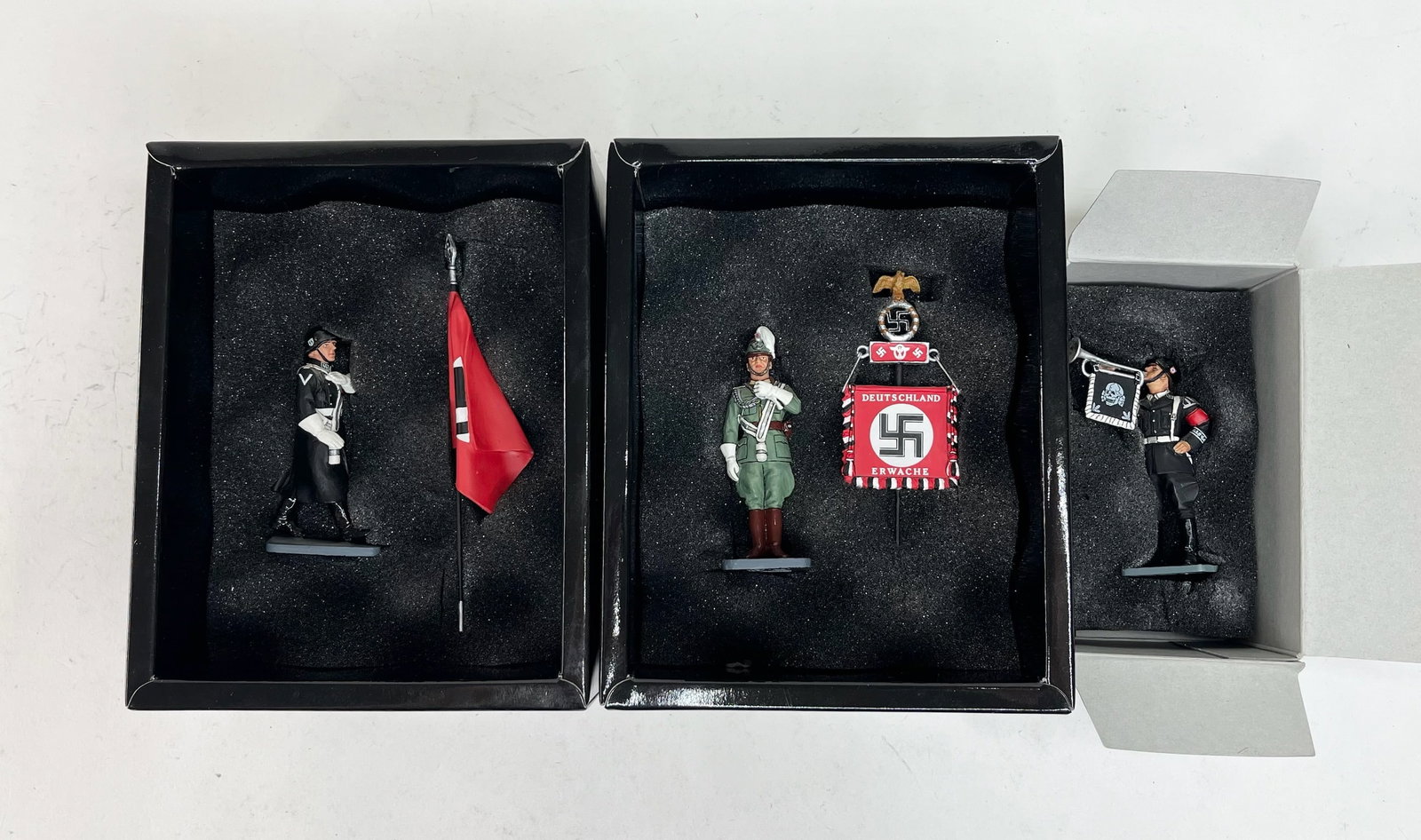 King & Country Berlin '38 Assortment: LAH038 Bugler, LAH071 Polizei Standard Bearer, LAH076 Winter SS w/Sflag. 3 Pieces. Condition Excellent. Boxes Excellent.