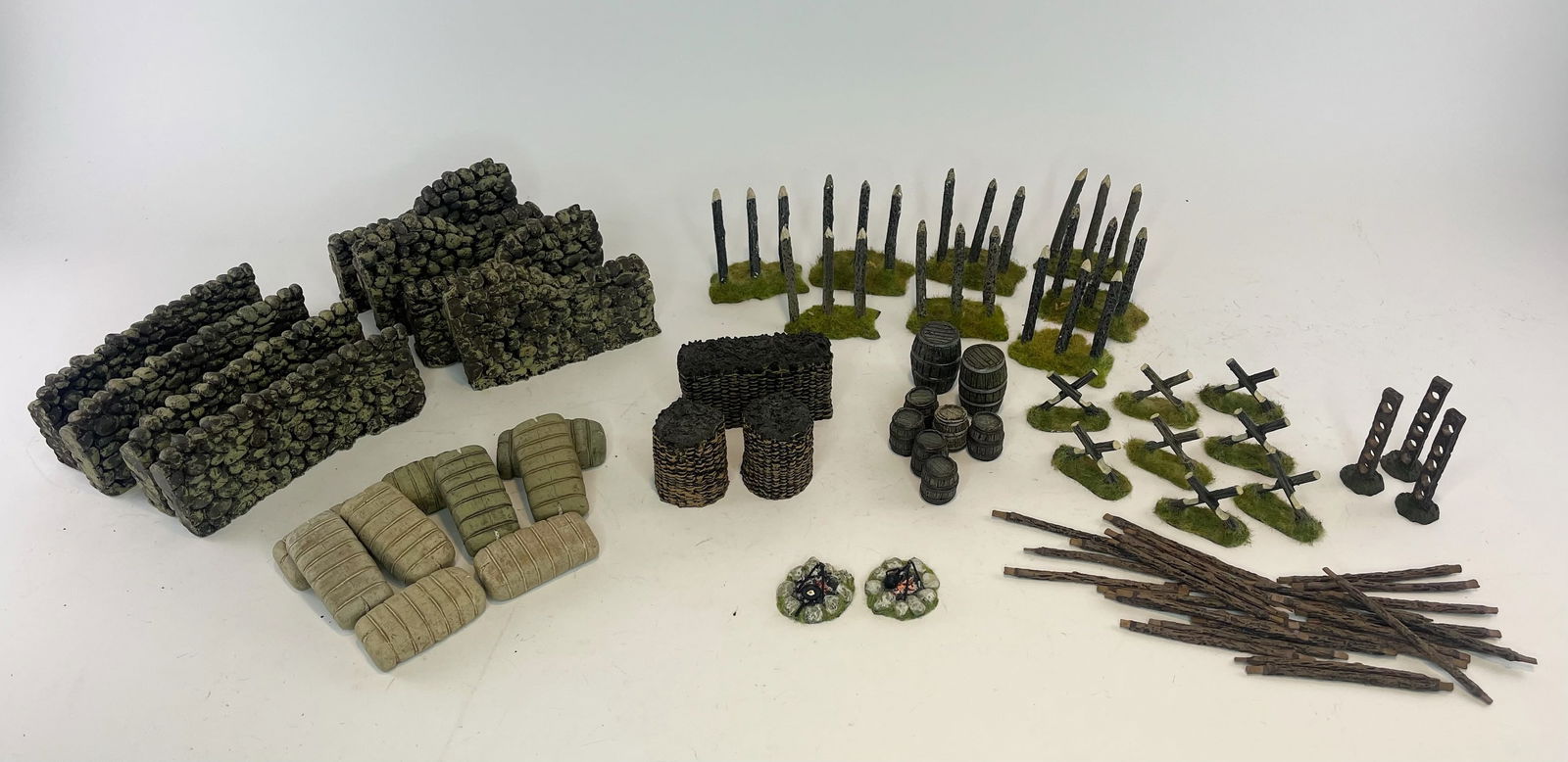 Diorama Accessory Assortment: 8 Cobblestone Walls, 8 Wooden Spike Barriers, 9 Sandbags, 8 Barrels, 3 Straw Barracades, 2 Campfires, 11 Fence Posts with 27 Rails. 76 Pieces Total. Condition Very Good. No Box.