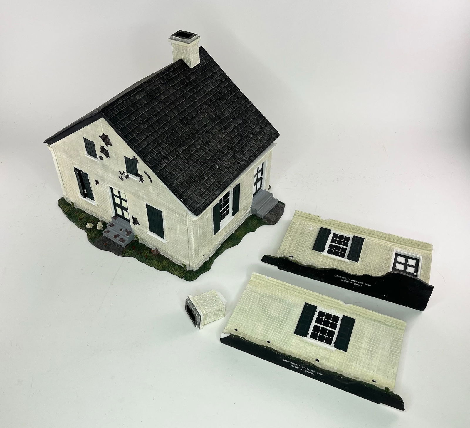 Britains House Diorama: Includes 2 End Walls, 4 Short Walls, 1 Roof, and 2 Chimneys. 9 Pieces Total. Assembled Measures Approximately 12x11x11 inches. Condition Good, Some Chips. No Box.