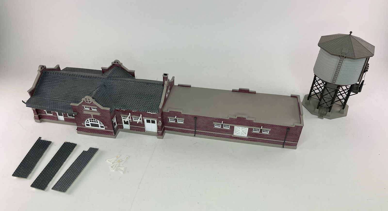 Diorama Assembly House and Water Tower: Unknown Makers. Assembly House Measures Approximately 20x7x5 inches. Water Tower Measures Approximately 4x4x7 inches. Condition Good. Assembly House has Some Supports and Roofing Pieces Broken but Pre