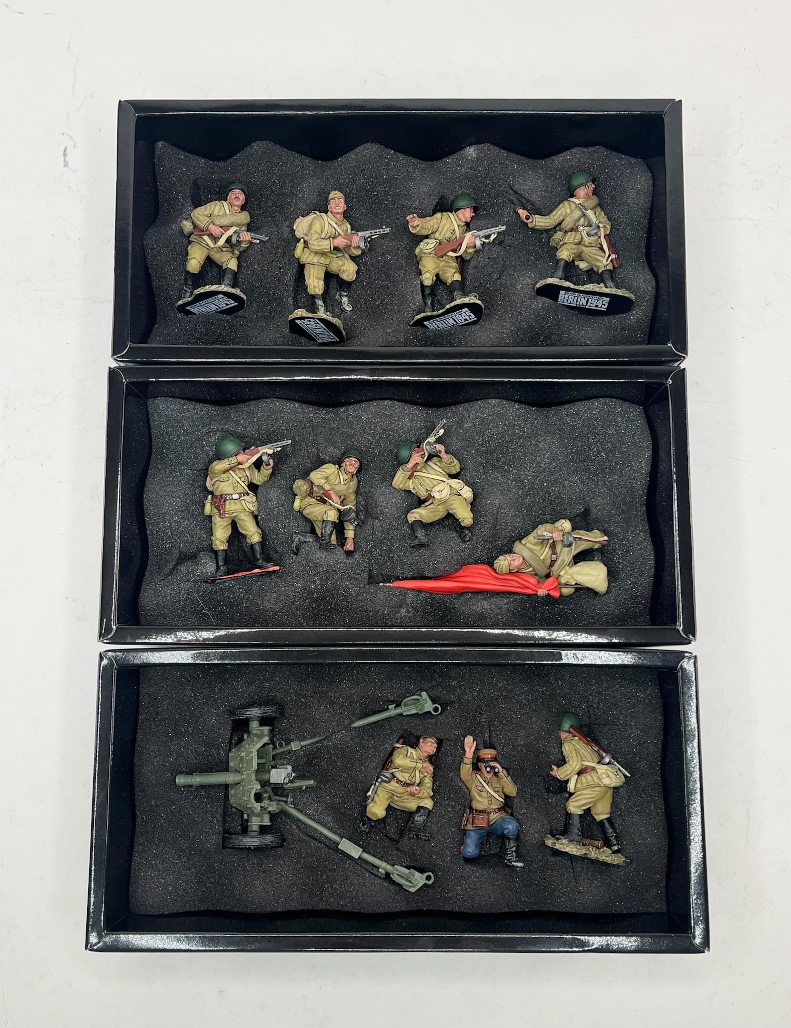 King & Country Fall of Berlin Set Assortment: Includes Sets RA008 The Attack Set, 4 Pieces, RA009 Soviet Tank Riders, 4 Pieces, and RA010 Russian Anti Tank Gun Set, 4 Pieces. 12 Pieces Total. Condition Excellent. Boxes Excellent.
