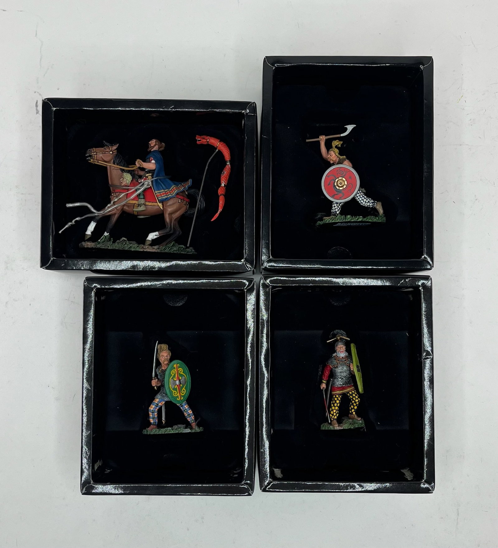 King & Country Roman Legion Barbarians Assortment: Includes BAR001 Mounted Chieftain by Honour Bound, BAR002 Attacking with Axe, BAR003 Attacking with Sword and Shield, and BAR004 Fighting Chief. 4 Pieces. Condition Excellent. Boxes Excellent.