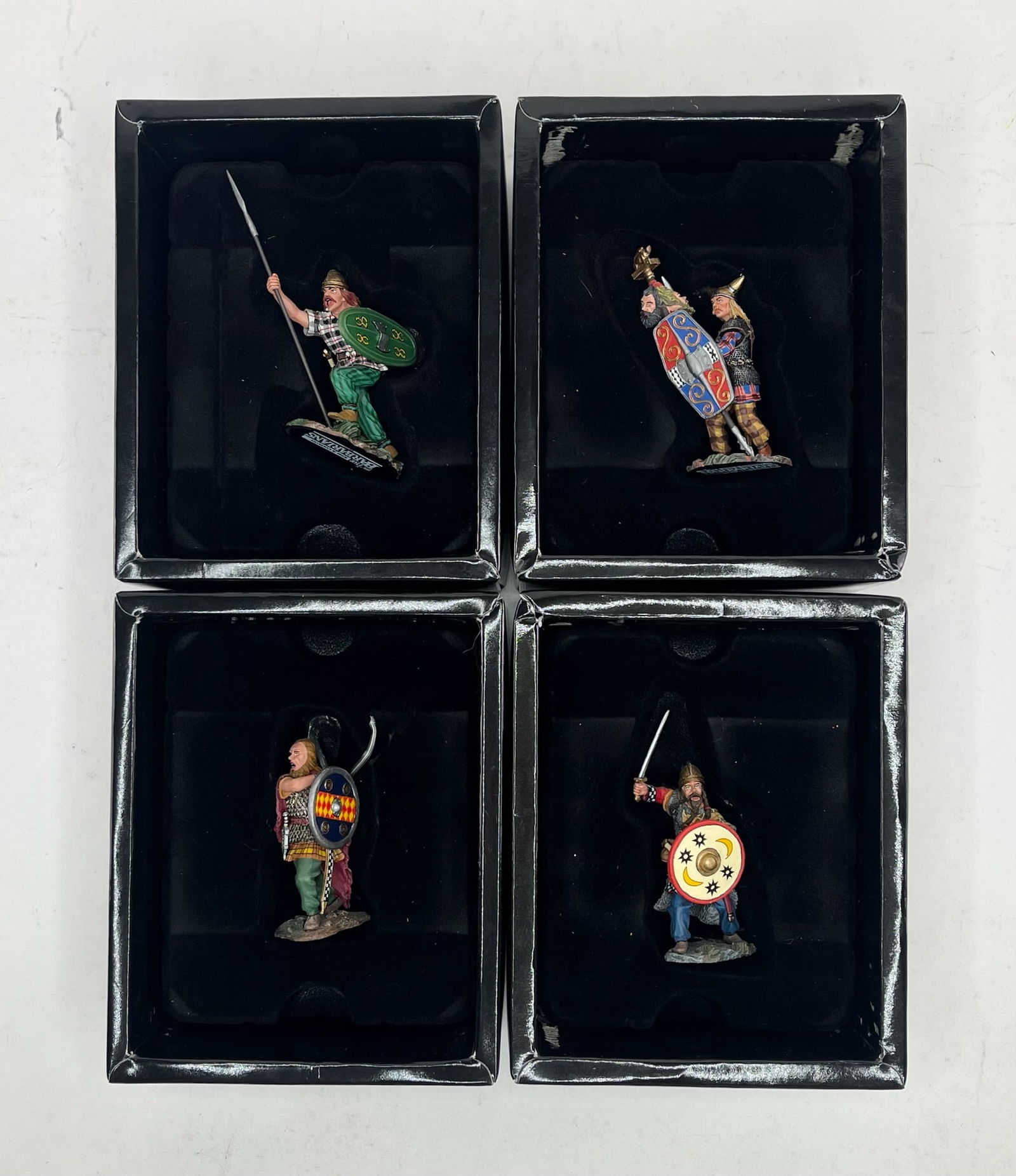King & Country Roman Legion Barbarians Assortment: Includes BAR005 Running with Sword and Shield, BAR006 Fighting Chief with two Heads, BAR007 Slashing Warrior with Shield, and BAR008 Running Warrior with Shield and Spear. 4 Pieces. Condition Excellen