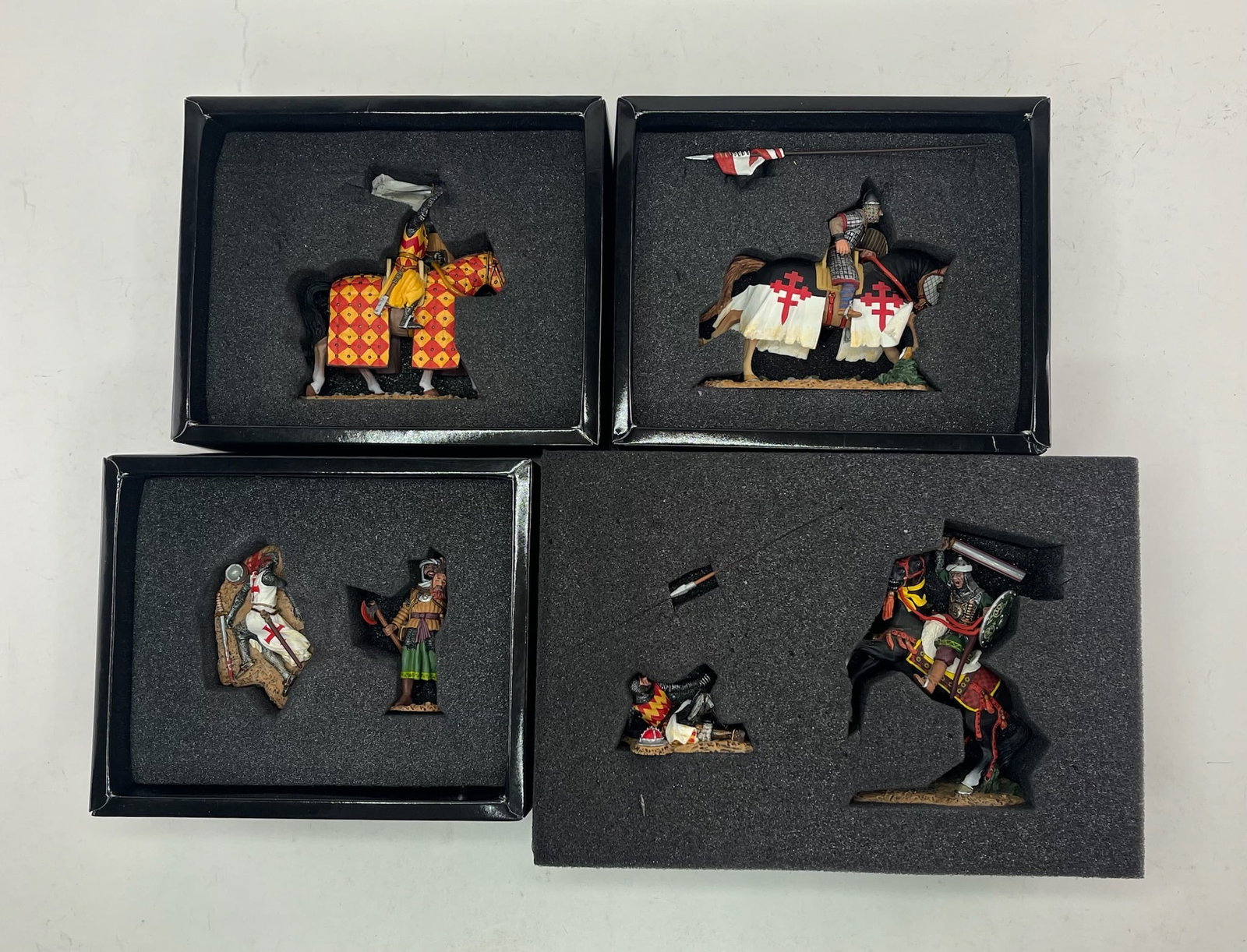 King & Country Crusaders and Saracens Assortment: Includes MK048 Attacking Crusader with Sword Mounted, MK049 Charging Crusader with Lance Mounted, MK050 Gruesome Trophy Set, and MK051 Fight to the Death. 6 Pieces. Condition Excellent. Boxes Excellen