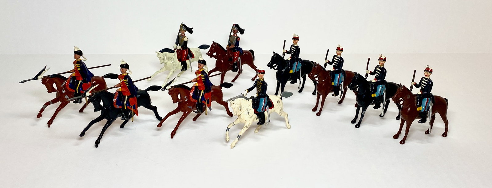 Britains Assorted Cavalry Figures: Pre and post war. Prussian Lancers from set #153, French Dragons from set #140, and Belgian Cavalry from set #190. 10 pieces. Excellent condition (one Prussian missing lance tip). Unboxed.