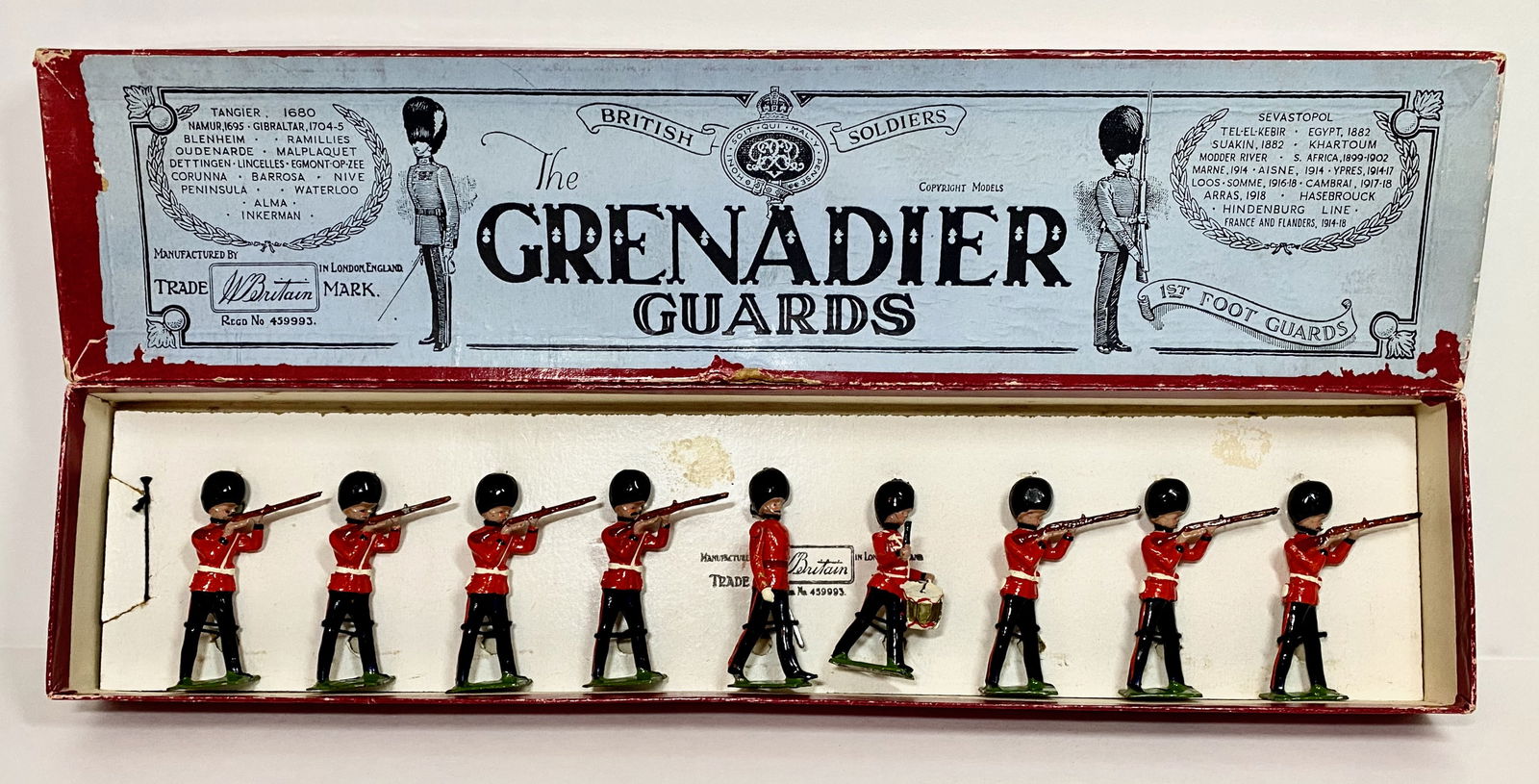 Britains #34 Grenadier Guards Firing: Post war. Retouched condition, retied to card in box. 9 pieces. Box good.