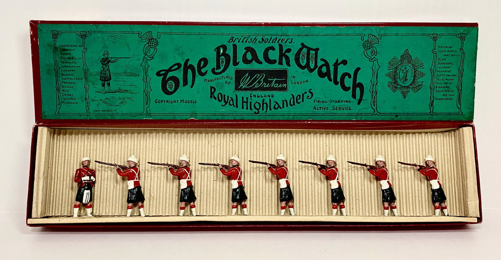 Britains #122 The Black Watch Firing: Pre war issue. 8 pieces. Near mint to excellent condition. Whisstock label box very good. FAO Schwarz label on top side.