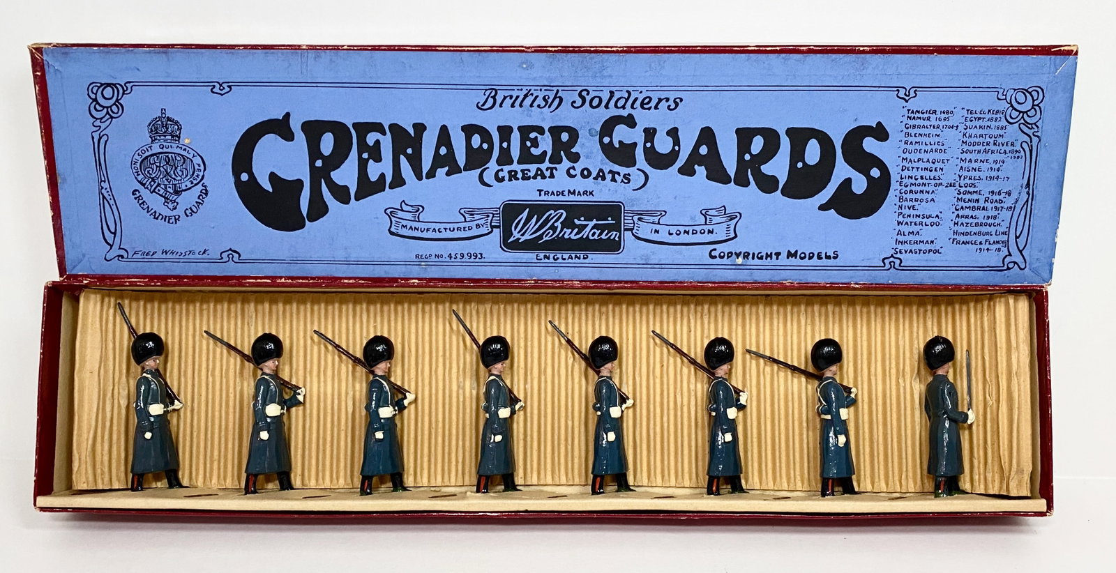Britains #312 Grenadier Guards: In winter great coats. 8 pieces. Near mint condition. FAO Schwarz label on one end of box. Whisstock label box excellent.