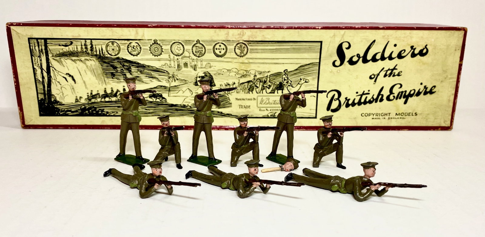 Britains #1260 British Infantry Firing: Third version, circa 1940. 9 pieces. One loose head, the rest in excellent condition. Box good.