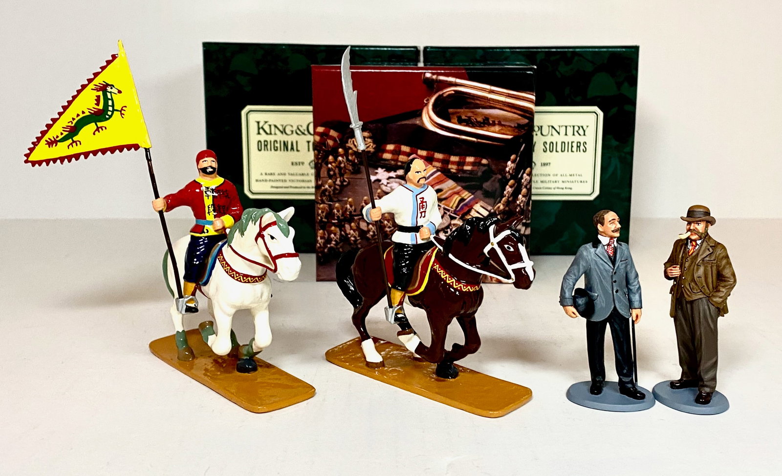 King & Country Assortment: #WOD066 Inspectors Lestrade & Bradstreet of Scotland Yard, plus two "Glossy" Mounted Chinese Warriors. Mint condition. Boxes excellent.