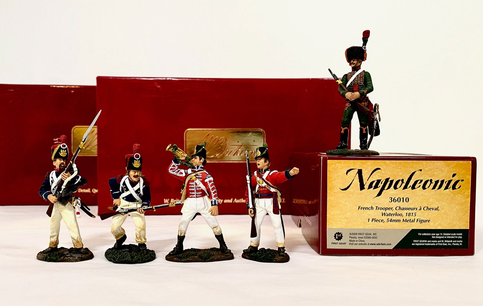 Britains Napoleonic Assortment: #36010 French Trooper Chasseurs a Cheval, #17847 French Light Infantry Grenadiers Assault, and #17883 British Coldstream Guards. 5 pieces. Mint condition. Box excellent.