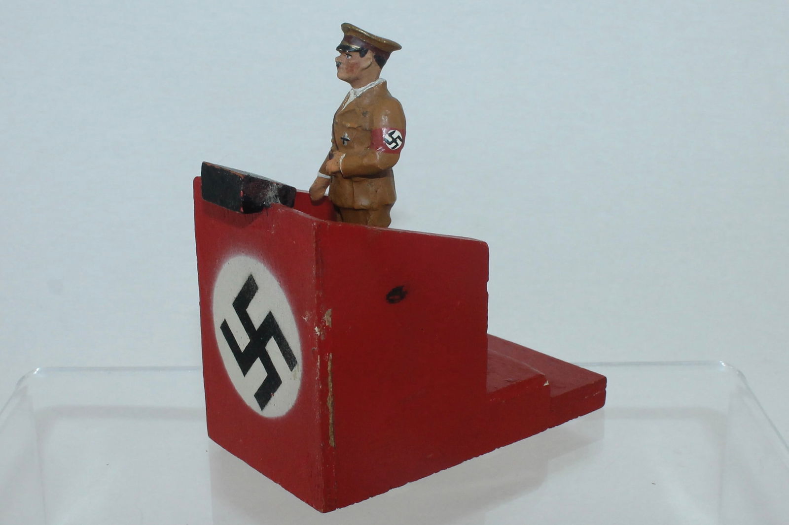 Elastolin Lot Hitler Standing with Podium: 30/50. Hitler in Party Uniform Standing on Wood Podium. Movable Arm and Composition Head. Podium Unmarked. 2 Pieces. Condition Excellent. No Box.