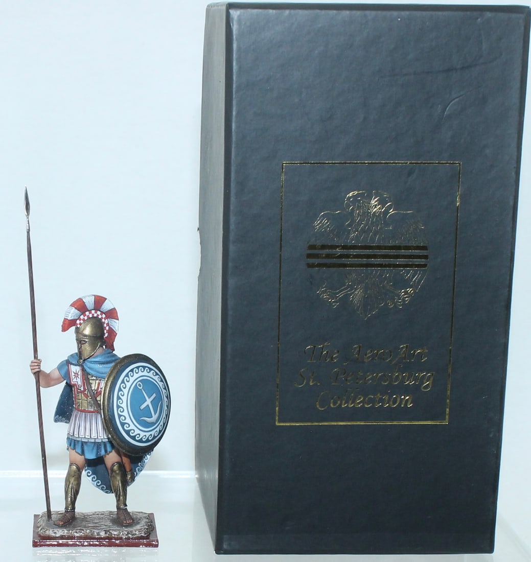 Aero Art Greek Hoplite Standing with Shield: St. Petersburg Collection. Aspis with Anchor. 6219 on Underside of Base. 1 Piece. Condition Very Good to Excellent. Minor Areas of Oxidation. Box Very Good.