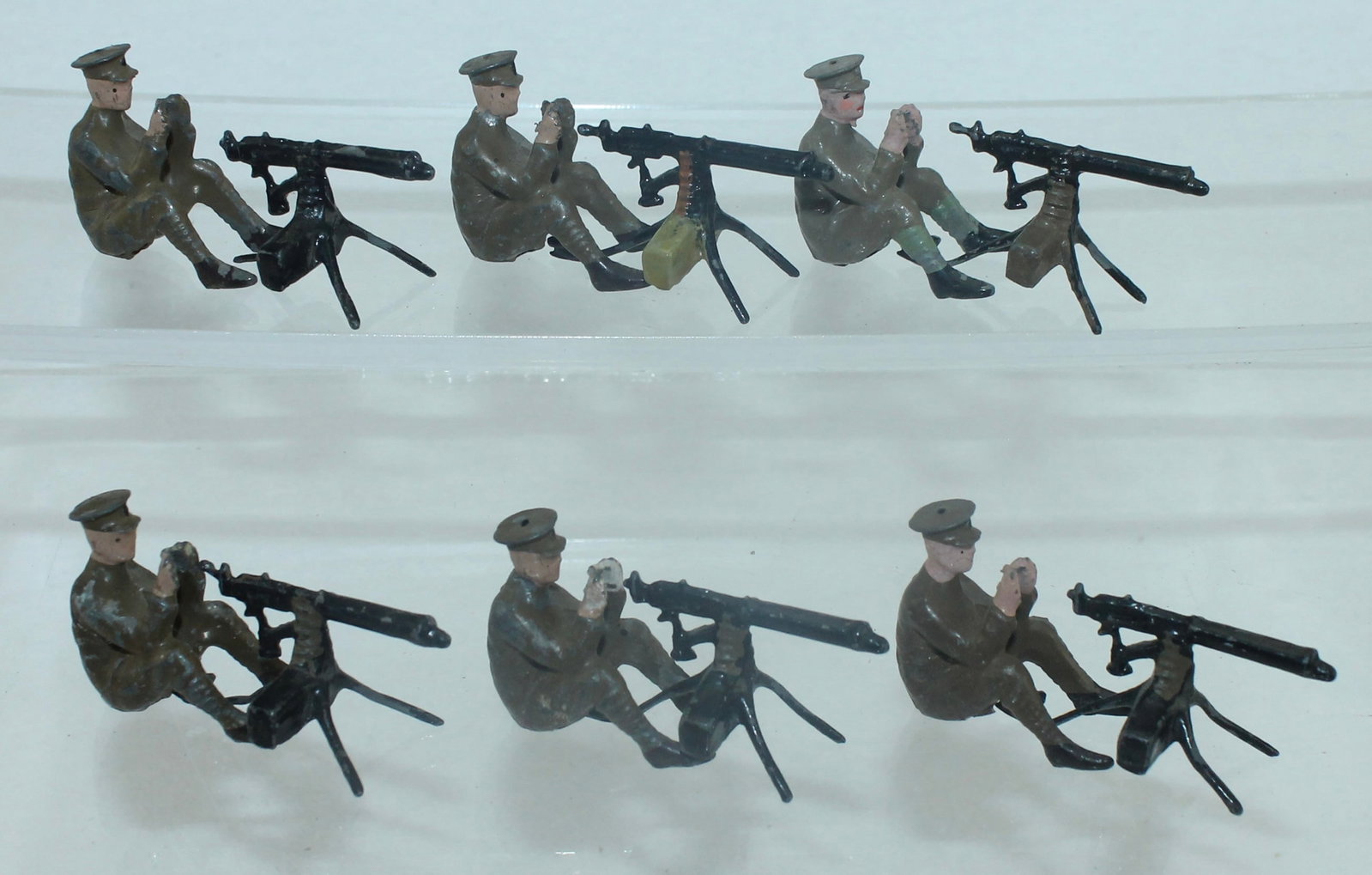 Britains From Set 1318 Machine Gun Section: Pre War. Includes 6 Men Seated and 6 Guns. 12 Pieces. Condition Good. One Machine Gun Slightly Damaged. No Box.